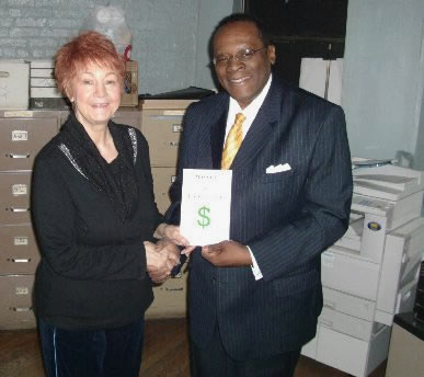 Dr. Reid presenting a copy of his book to Edith M. Stranges